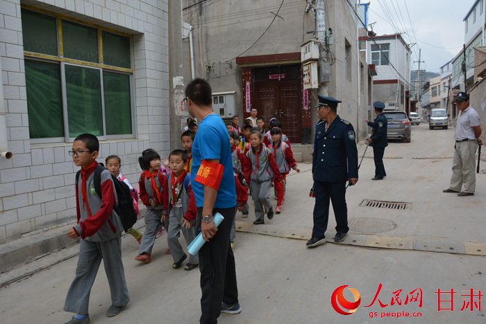 保安持械護(hù)送孩子去乘車點(diǎn)（劉海天 攝）