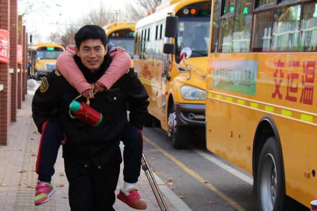 校車駕駛員寒冬背學(xué)生上學(xué) 定格在冷風(fēng)中的溫暖瞬間